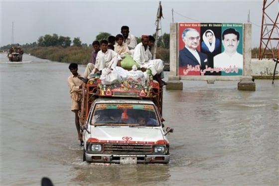 Pakistani flood survivors flee to safe areas in Lundi village near Karampur, Pakistan, on Sept. 2. Allegations that powerful government officials and landowners used their influence to divert floodwaters away from their property and over the villages and fields of millions of poor citizens have stoked outrage in Pakistan.